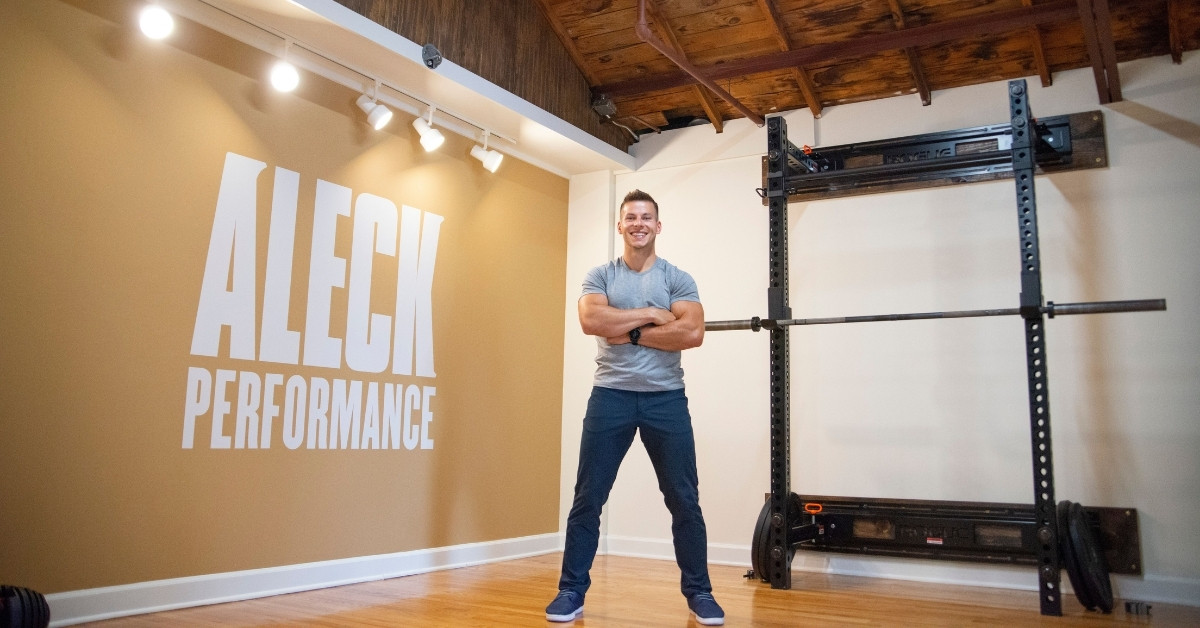 Chiropractor Standing In Front of Squat Bench